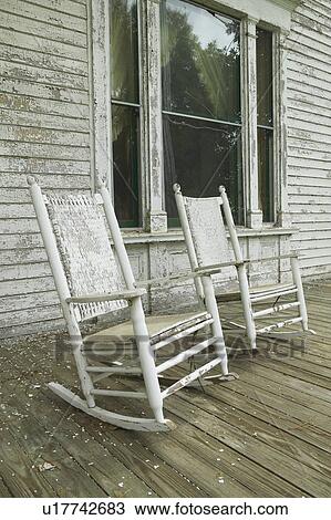 Stock Image - Rocking chairs on porch of southern house. Fotosearch