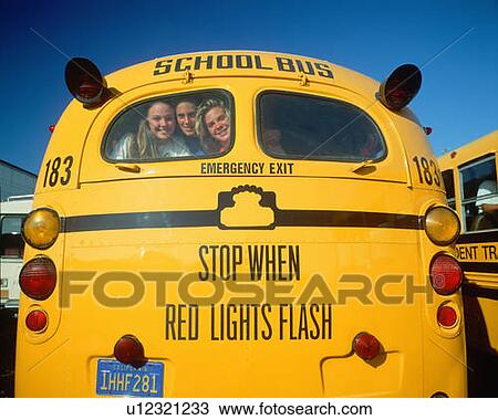 School girls smiling from back of yellow school bus View Large Photo Image Stock Image - School girls smiling from back of yellow school bus. Fotosearch