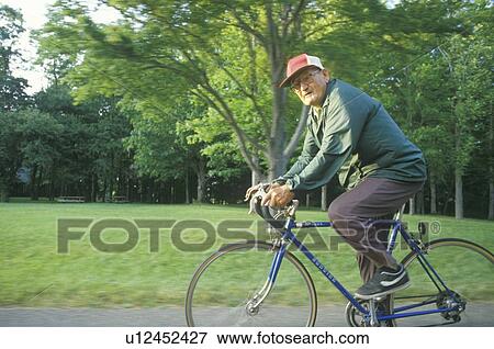 Senior male citizen bicycling View Large Photo Image Stock Photo - Senior male citizen bicycling. Fotosearch