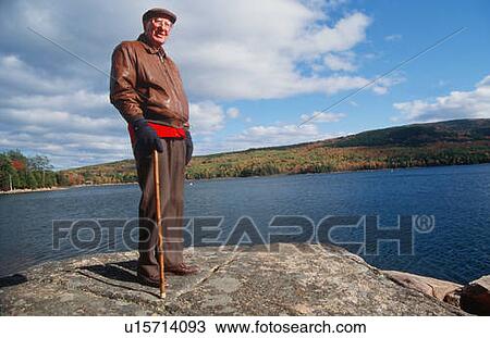 Stock Image - Senior Takes Autumn Walk, Acadia National Park, Maine. Fotosearch