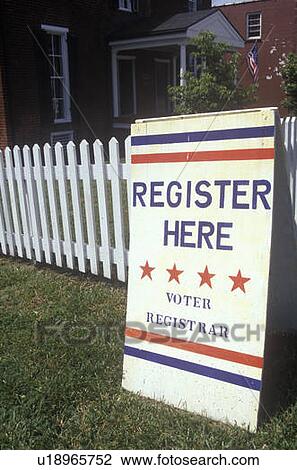 Sign in front of white picket fence reads Register Here View Large Photo Image Stock Image - Sign in front of white picket fence reads Register Here. Fotosearch