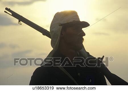 Stock Photo - Silhouette of soldier at sunset with gun during reenactment of Battle of Manassas. Fotosearch