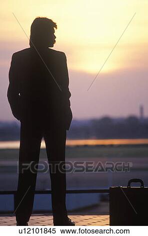 Silhouetted rear view of businessman on a Metrorail train platform View Large Photo Image Stock Photography - Silhouetted rear view of businessman on a Metrorail train platform. Fotosearch