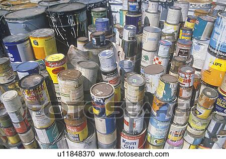 Stock Image - Stacks of toxic paint cans waiting for disposal. Fotosearch
