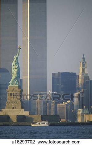 Stock Image - Statue of Liberty with the World Trade Center Buildings at Sunset, New York City, New York. Fotosearch