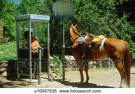Suburban cowboy using a pay telephone View Large Photo Image Stock Photography - Suburban cowboy using a pay telephone. Fotosearch
