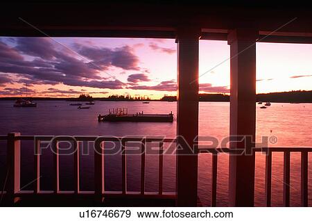 Stock Photo - Sunset from porch overlooking lake. Fotosearch