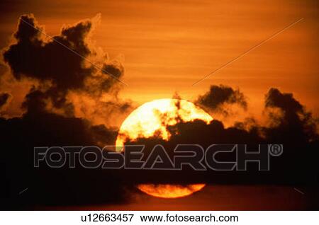 Sunset with silhouetted clouds View Large Photo Image Stock Photo - Sunset with silhouetted clouds. Fotosearch
