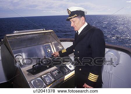 Stock Photo - The captain of the ferry Bluenose piloting the ship. Fotosearch
