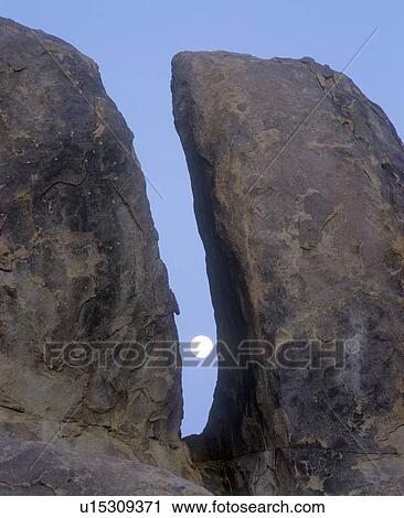 Stock Image - The Moon Between Two Rocks, Alabama Hills, California. Fotosearch