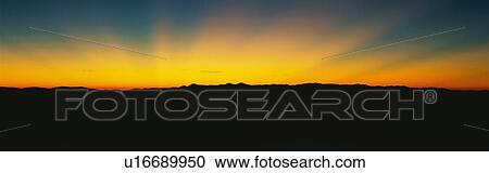 Stock Image - These are God Rays at sunrise over the Great Smoky Mountains.. Fotosearch