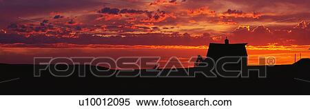 This is a farm at sunset. The farm house is silhouetted against an orange sky. View Large Photo Image Stock Photography - This is a farm at sunset. The farm house is silhouetted against an orange sky.. Fotosearch