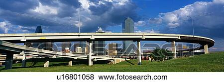 Stock Photo - This is a freeway overpass with the Dallas skyline visible behind it. Fotosearch