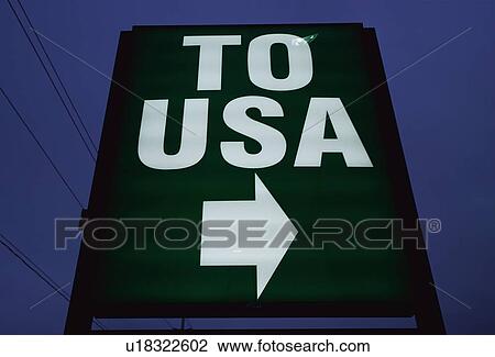Stock Image - This is a road sign that says, To USA, with a white arrow pointing to the right. Fotosearch