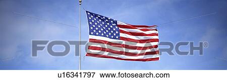 This is a shot of an American flag on a flagpole View Large Photo Image Stock Photo - This is a shot of an American flag on a flagpole. Fotosearch