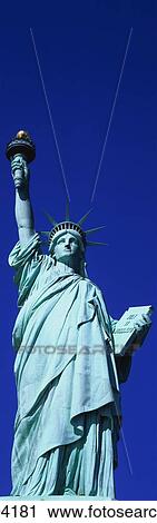 This is a vertical shot of the Statue of Liberty against a blue sky. View Large Photo Image Stock Image - This is a vertical shot of the Statue of Liberty against a blue sky.. Fotosearch