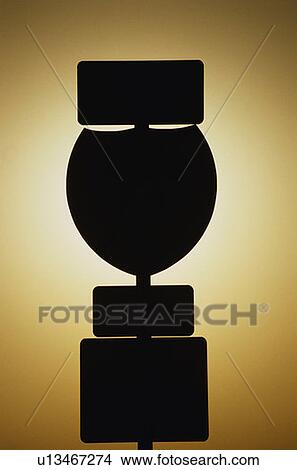 Picture - This is an interstate sign at sunset. It is silhouetted against a yellow sunset sky. . Fotosearch