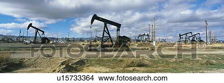 This is an oil field with black oil rigs pumping for oil. View Large Photo Image Picture - This is an oil field with black oil rigs pumping for oil. . Fotosearch