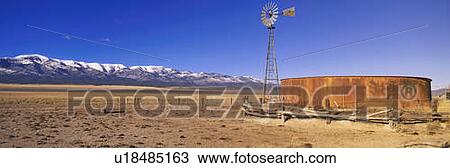 This is an old wooden windmill in an open field in the old west. View Large Photo Image Stock Image - This is an old wooden windmill in an open field in the old west. . Fotosearch