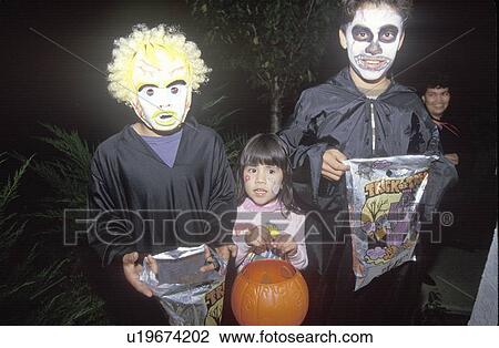 Three children trick or treating for Halloween View Large Photo Image Stock Image - Three children trick or treating for Halloween. Fotosearch