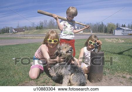 Picture - Three children with their dog playing. Fotosearch