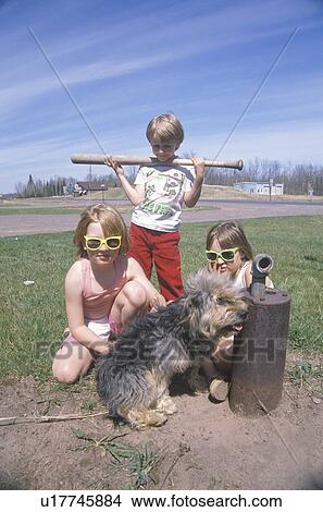 Picture - Three children with their dog playing. Fotosearch