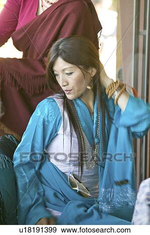 Stock Photo - Tibetan woman in traditional dress attends Amitabha Empowerment Buddhist Ceremony. Fotosearch