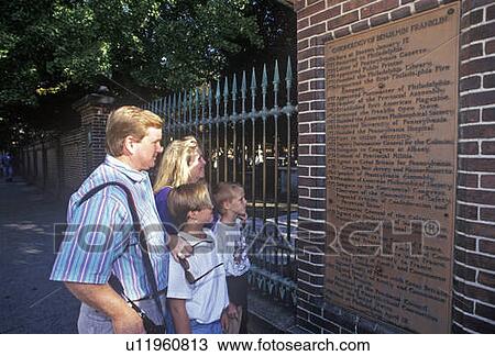 Stock Image - Tourists at Benjamin Franklin historical gravesite, Philadelphia, PA. Fotosearch