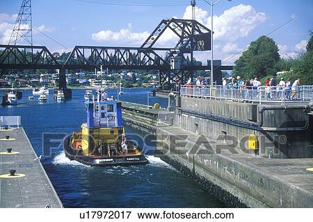 Stock Photo - Tug boat going through Hiram M. Chittenden Locks on Puget Sound, Seattle, WA. Fotosearch