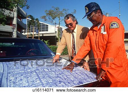 Two ethnic men reviewing blueprints at job site View Large Photo Image Stock Image - Two ethnic men reviewing blueprints at job site. Fotosearch
