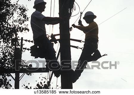 Two telephone repairmen working on pole View Large Photo Image Stock Photography - Two telephone repairmen working on pole. Fotosearch
