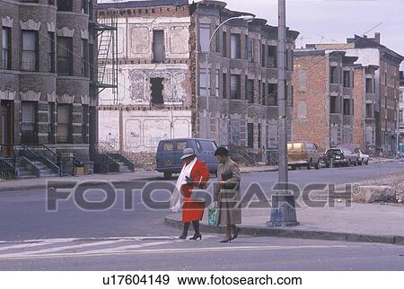 Two women crossing street in ghetto View Large Photo Image Stock Photo - Two women crossing street in ghetto. Fotosearch