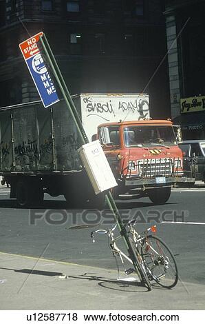 Stock Photo - Vandalized bicycle and graffiti covered truck. Fotosearch