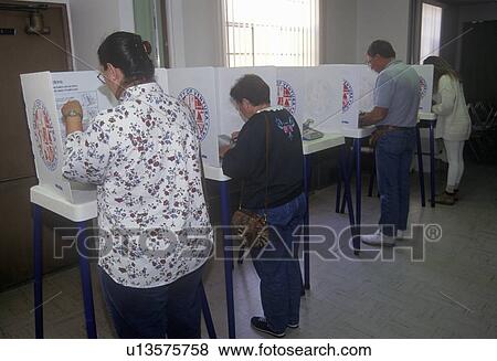 Voters and voting booths in a polling place View Large Photo Image Stock Photo - Voters and voting booths in a polling place. Fotosearch