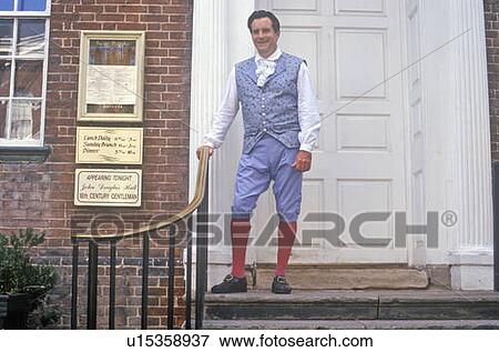 Stock Photo - Waiter poses in front of Gadsby's Tavern Museum in Old Town Alexandria, Alexandria, Washington, DC. Fotosearch