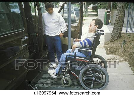 Wheelchair bound young man getting into specially equipped van View Large Photo Image Picture - Wheelchair bound young man getting into specially equipped van. Fotosearch
