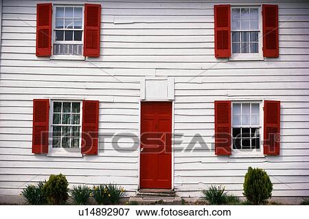 Stock Photo - White house with red shutters. Fotosearch
