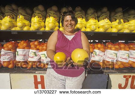 Woman holding grapefruits View Large Photo Image Stock Photo - Woman holding grapefruits. Fotosearch