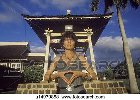 Woman meditates at shrine in Buddhist Cemetery in Maui Hawaii View Large Photo Image Stock Photo - Woman meditates at shrine in Buddhist Cemetery in Maui Hawaii. Fotosearch