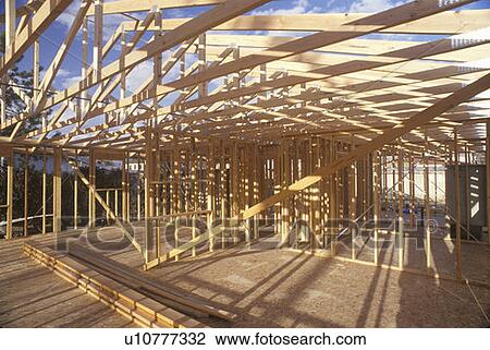 Stock Image - Wood frame of house under construction, Lone Pine, CA. Fotosearch