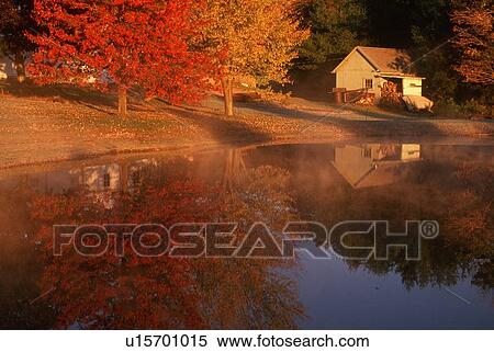 Stock Photography - Wood shed on lake in autumn. Fotosearch