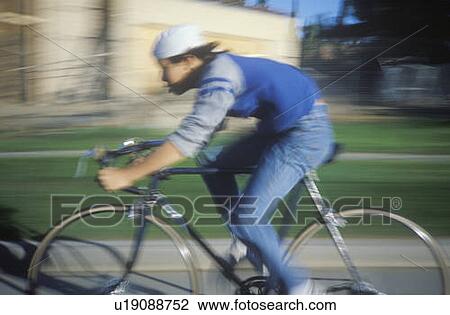 Young man riding bicycle View Large Photo Image Stock Image - Young man riding bicycle. Fotosearch