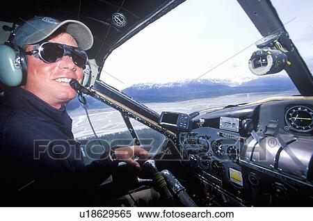 A bush pilot in a scout plane in Alaska View Large Photo Image Stock Photography - A bush pilot in a scout plane in Alaska. Fotosearch
