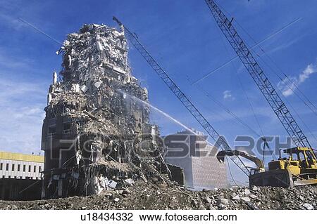 Stock Image - A demolition crew tearing down remnants from a building. Fotosearch