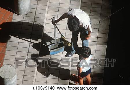 Stock Image - A janitor speaks with a small boy. Fotosearch