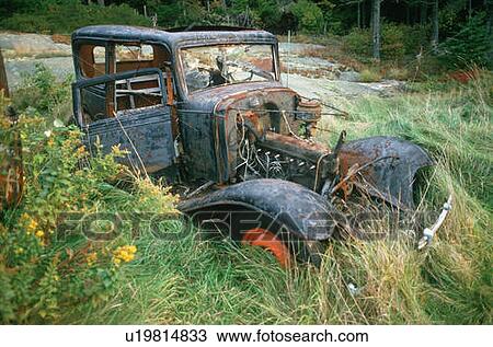 Stock Image - A junk car in Maine. Fotosearch