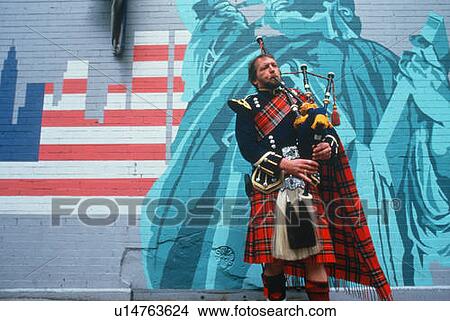 A man in kilt playing bagpipes in front of a patriotic mural View Large Photo Image Picture - A man in kilt playing bagpipes in front of a patriotic mural. Fotosearch