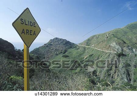Stock Photo - A posted sign reads Slide Area. Fotosearch