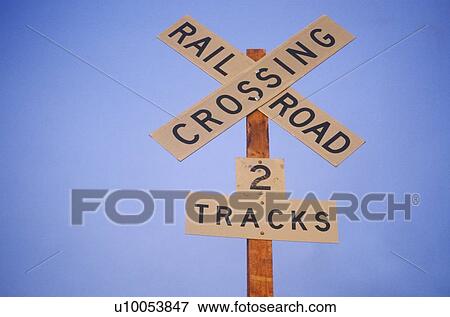 A railroad crossing sign off of Route 95 View Large Photo Image Stock Photo - A railroad crossing sign off of Route 95. Fotosearch