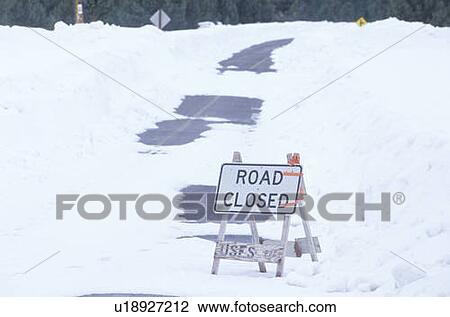 Stock Image - A road closed sign in the snow. Fotosearch